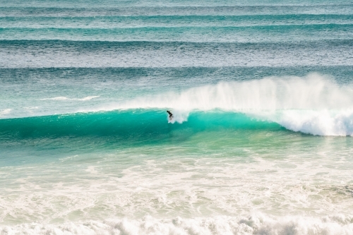 A surfer riding a long barrel wave on the Gold Coast - Australian Stock Image