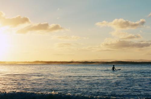 A surfer waiting on the water - Australian Stock Image