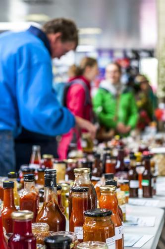 A table of bottle preserves and chutney being judged at a country fair - Australian Stock Image