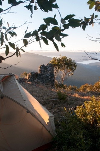 A tent and camp overlooking mountain range