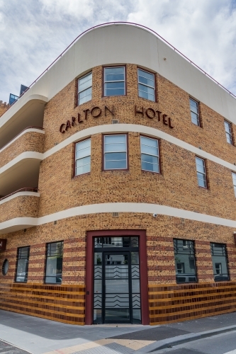 A three storey art deco hotel on a street corner - Australian Stock Image
