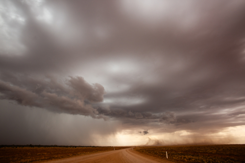 A thunderstorm rolls across the plains in outback Queensland - Australian Stock Image