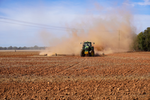 A tractor working the ground in preparation for sowing crops - Australian Stock Image