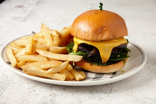 A vegetarian mushroom burger served with chips - Australian Stock Image