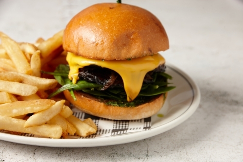 A vegetarian mushroom burger served with chips - Australian Stock Image