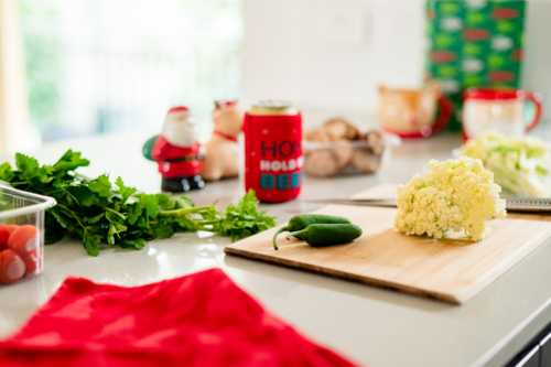 A vibrant kitchen filled with Christmas decorations and fresh ingredients for holiday cooking - Australian Stock Image