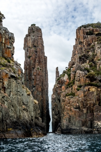 A view of Cape Hauy and the Candle Stick from the water - Australian Stock Image