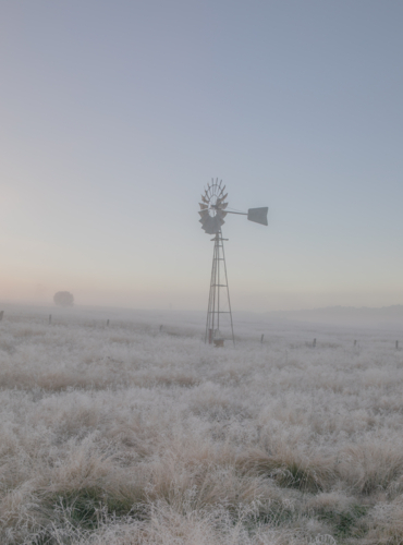 A windmill in a frozen field - Australian Stock Image