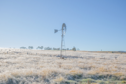 A windmill in a frozen field on a winter's morning - Australian Stock Image
