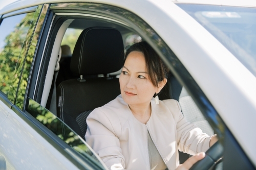 A woman driving to work on a suv car - Australian Stock Image