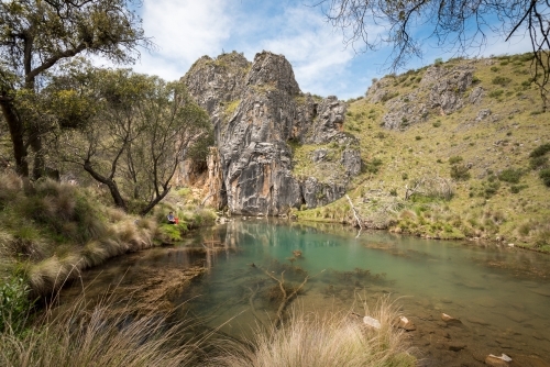 A Woman Resting by the Blue Holes in Kosciuszko - Australian Stock Image