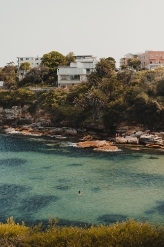 A woman swimming in the idyllic clear water at Gordons Bay. - Australian Stock Image