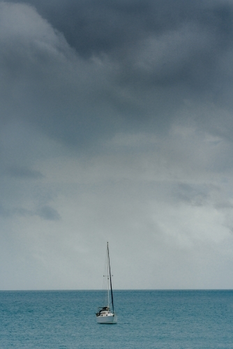 A yacht at sea with stormy skies - Australian Stock Image