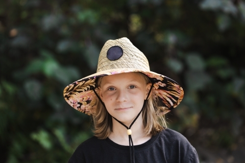 A young australian 11 year old girl wearing a sun smart wide brimmed hat - Australian Stock Image