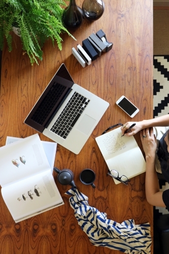A young creative female worker at her office desk from above - Australian Stock Image