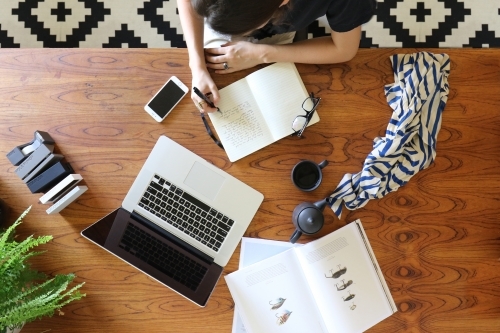 A young creative female worker at her office desk from above - Australian Stock Image