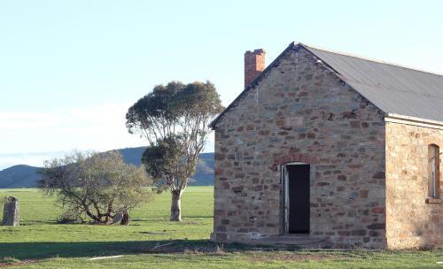 Abandoned brick building in a green paddock - Australian Stock Image