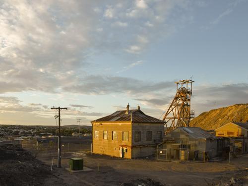 Abandoned poppet head and buildings at a mine site
