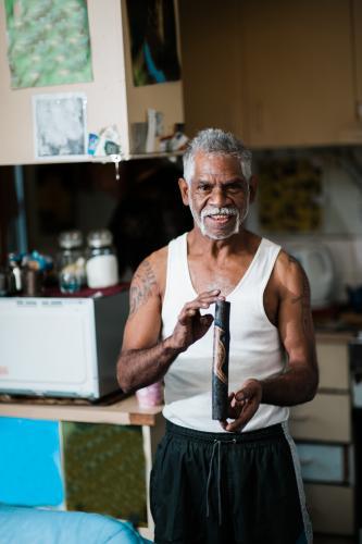 Aboriginal Artist holding Work of Art - Australian Stock Image