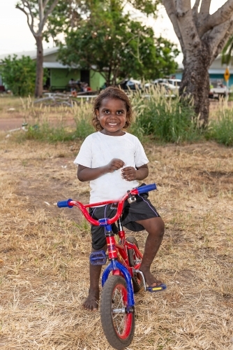 Aboriginal boy on bike - Australian Stock Image
