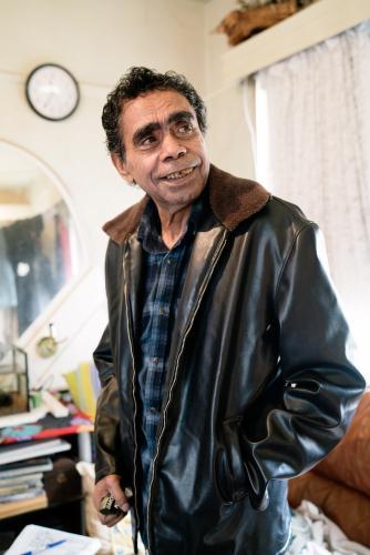 Aboriginal Elder Standing Indoors - Australian Stock Image