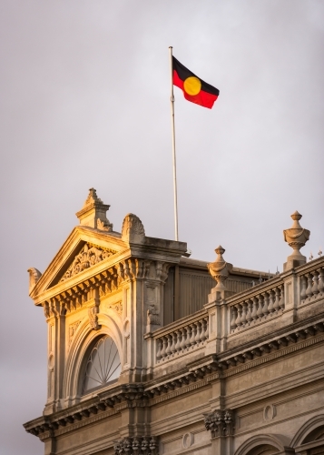 aboriginal flag flying above a heritage building