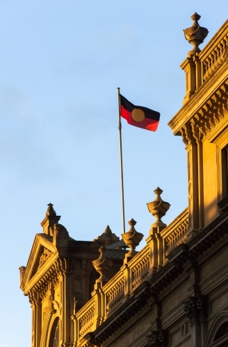 aboriginal flag flying above a heritage building - Australian Stock Image
