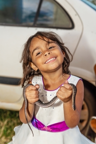 Aboriginal girl with snake - Australian Stock Image