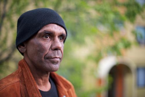 Aboriginal Man in his Forties, Tree in Background - Australian Stock Image