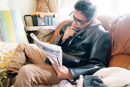 Aboriginal Man Reading a Newspaper - Australian Stock Image