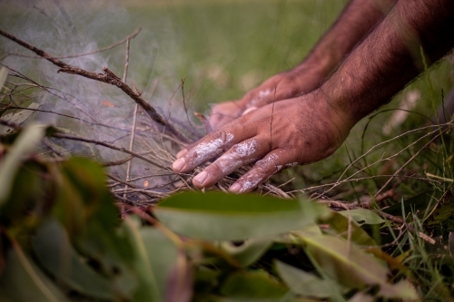 Aboriginal man starting a fire - Australian Stock Image