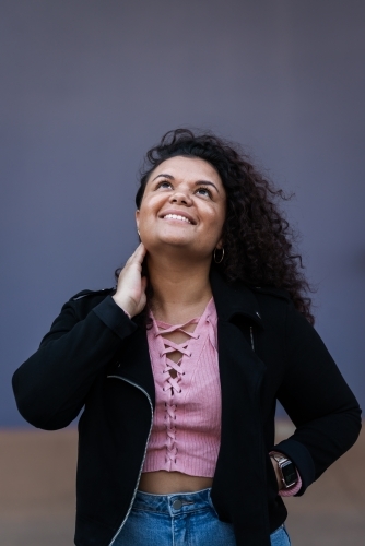 aboriginal woman with curly hair, looking up - Australian Stock Image