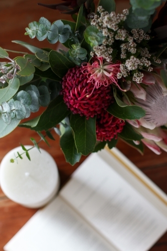 Above angle close up of native floral arrangement with notebook in the background - Australian Stock Image