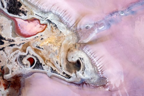 Abstract aerial view of salt lake textures in pink, beige and pink purple tones - Australian Stock Image
