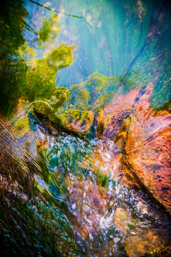 Abstract blend of light and water over river stones - Australian Stock Image