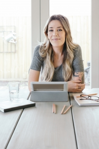 Accomplished young woman working at home - Australian Stock Image