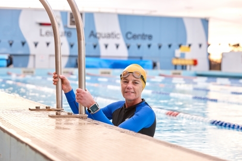 Active senior lady exercising in swimming pool