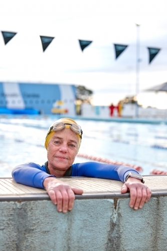 Active senior lady exercising in swimming pool - Australian Stock Image