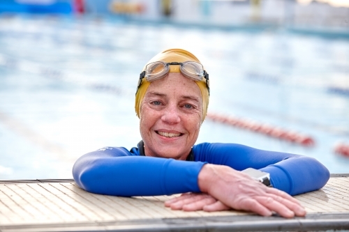 Active senior lady exercising in swimming pool - Australian Stock Image