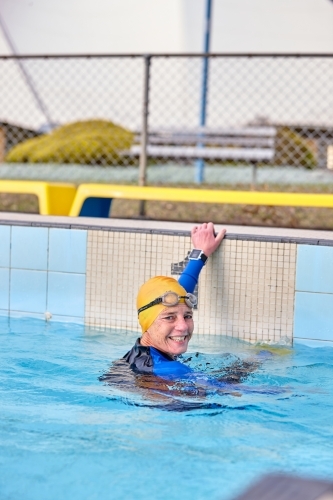 Active senior lady exercising in swimming pool - Australian Stock Image