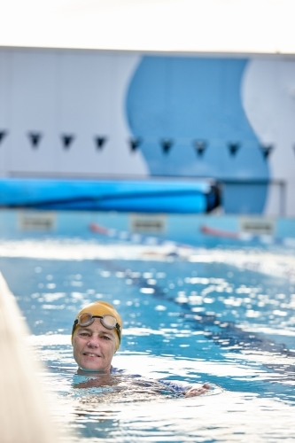 Active senior lady in swimming pool - Australian Stock Image
