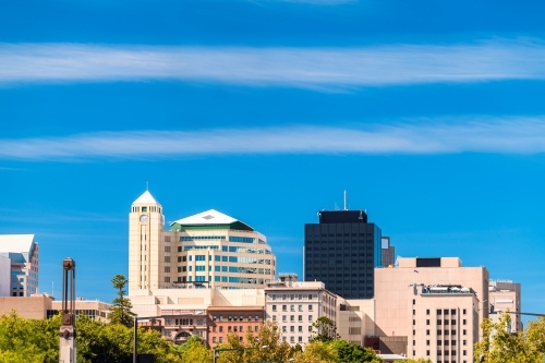 Adelaide CBD skyline viewed from King William street on a bright day against blue sky - Australian Stock Image