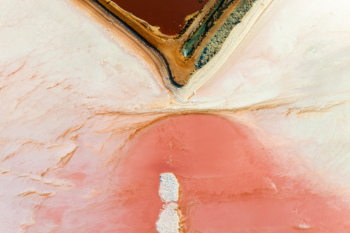 Aerial abstract of salt ponds with vivid red and pink tones. - Australian Stock Image
