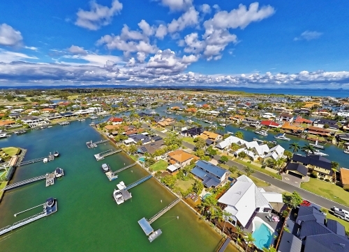 Aerial drone uav footage over waterfront properties with private jetties and solar panels in Newport - Australian Stock Image