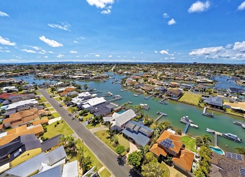 Aerial drone uav footage over waterfront properties with private jetties and solar panels in Newport - Australian Stock Image