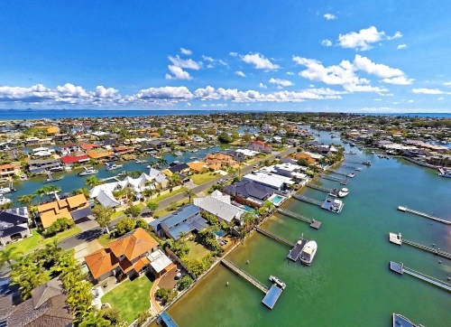 Aerial drone uav footage over waterfront properties with private jetties and solar panels in Newport - Australian Stock Image