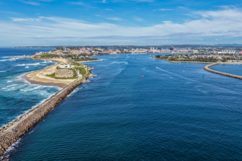 Aerial drone view of Nobbys Lighthouse and breakwall with Newcastle harbour - Australian Stock Image