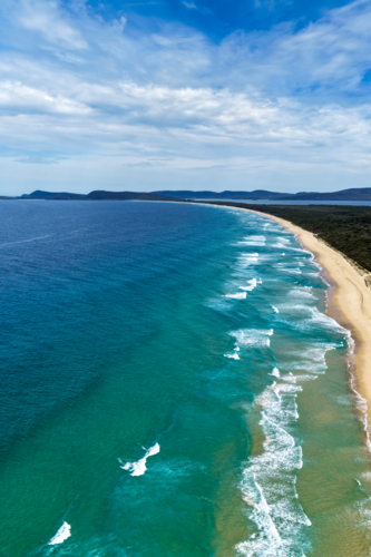 Aerial drone view of Seven Mile Beach in Forster showcasing a long stretch of sandy shoreline. - Australian Stock Image