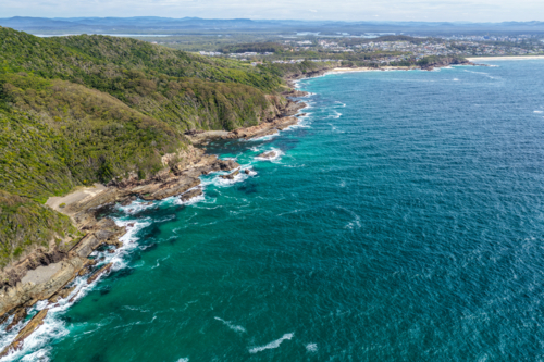 Aerial drone view over McBrides rockpool showing the natural rock formation along a rugged coastline - Australian Stock Image
