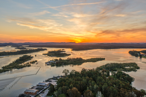 Aerial image capturing the Coolongolook River in Tuncurry at sun set - Australian Stock Image